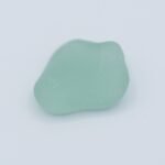 a piece of seafoam beach glass