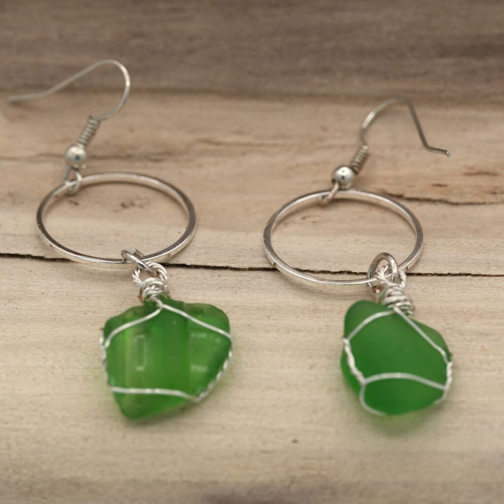 a pair of silver-wrapped green beach glass earrings